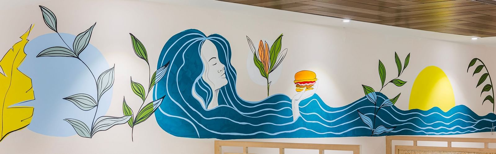 Lemonridge Hotels, KPHB | Close-up of artistic wall decorations in the dining area. Whimsical and colorful designs.